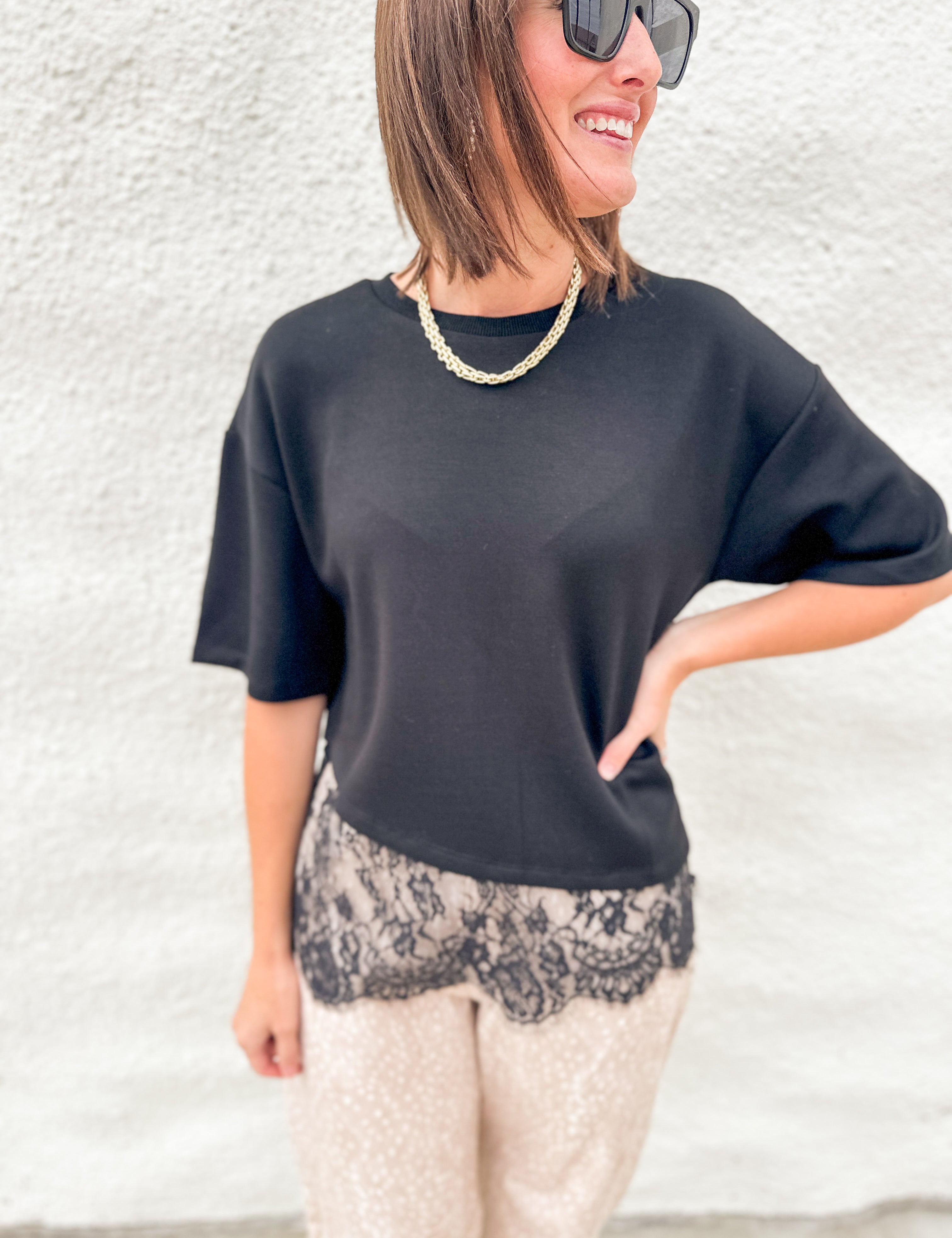 Black scuba tee shirt with lace hem asymmetric hem detail, fawn print barrel pants
