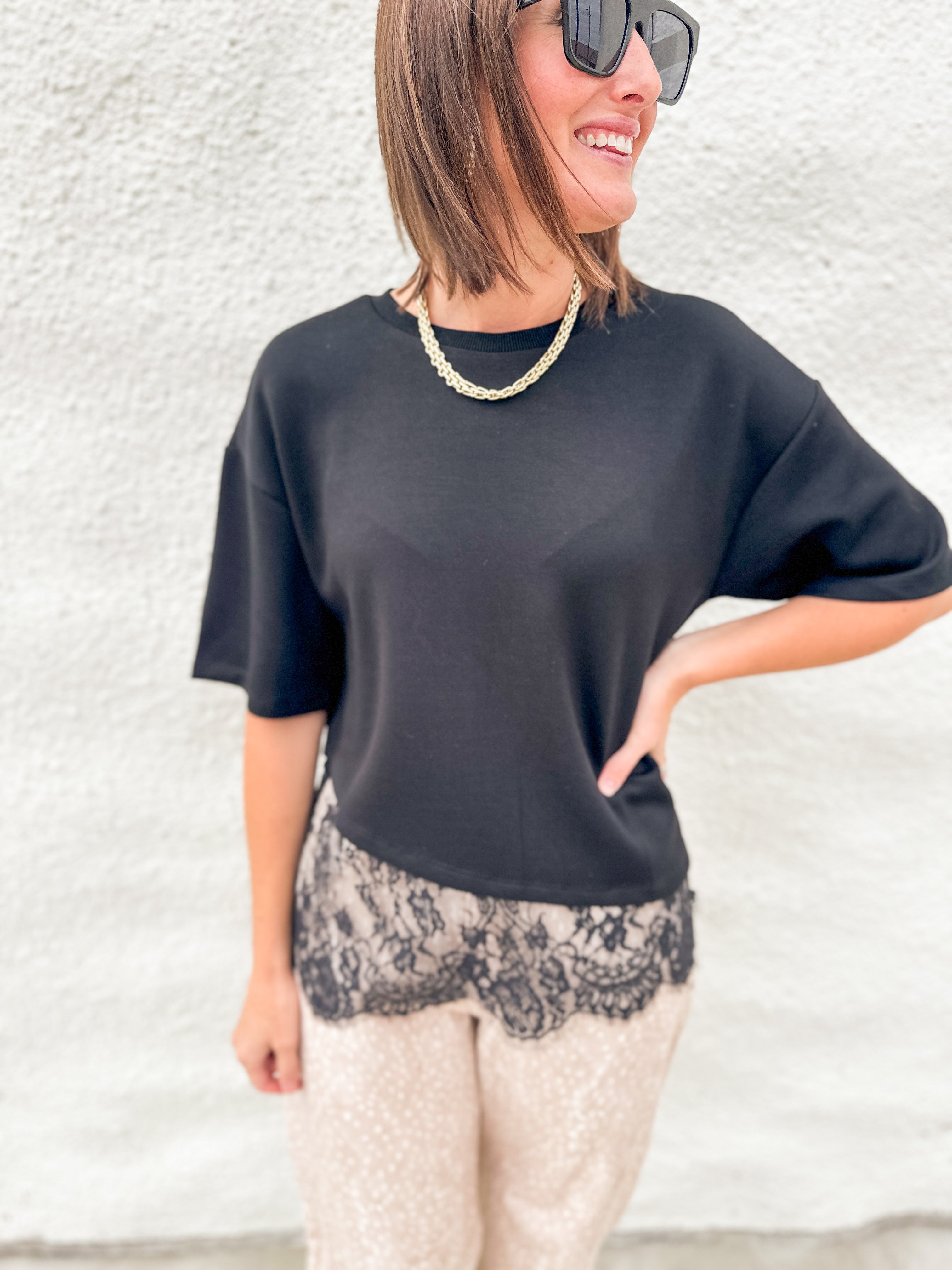 Black scuba tee shirt with lace hem asymmetric hem detail, fawn print barrel pants