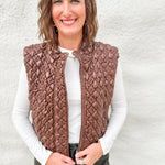 Model wearing a quilted brown vest with a faux leather look layered over a white ribbed long sleeve tee and green barrel denim from Daze