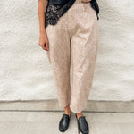 Woman wearing scuba black tee with lace hem detail and fawn printed barrel denim jeans with black loafer mules