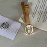 Gold watch with mesh gold wristband with white mother of pearl look face