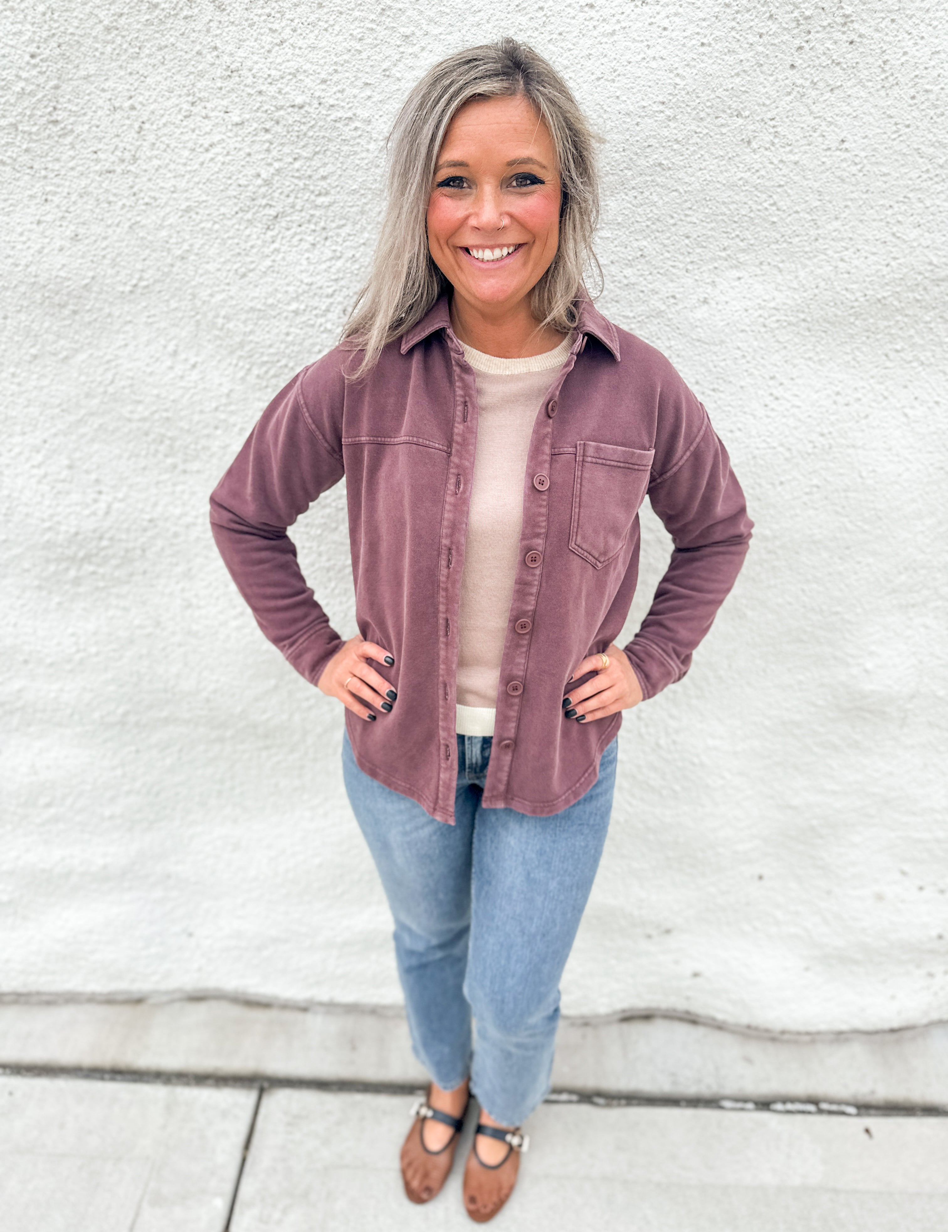 Woman wearing a washed mahogany soft button down collared soft shacket with front pocket detail on the left chest from Thread & Supply, wearing straight leg denim and brown and black mesh Mary Jane Flats