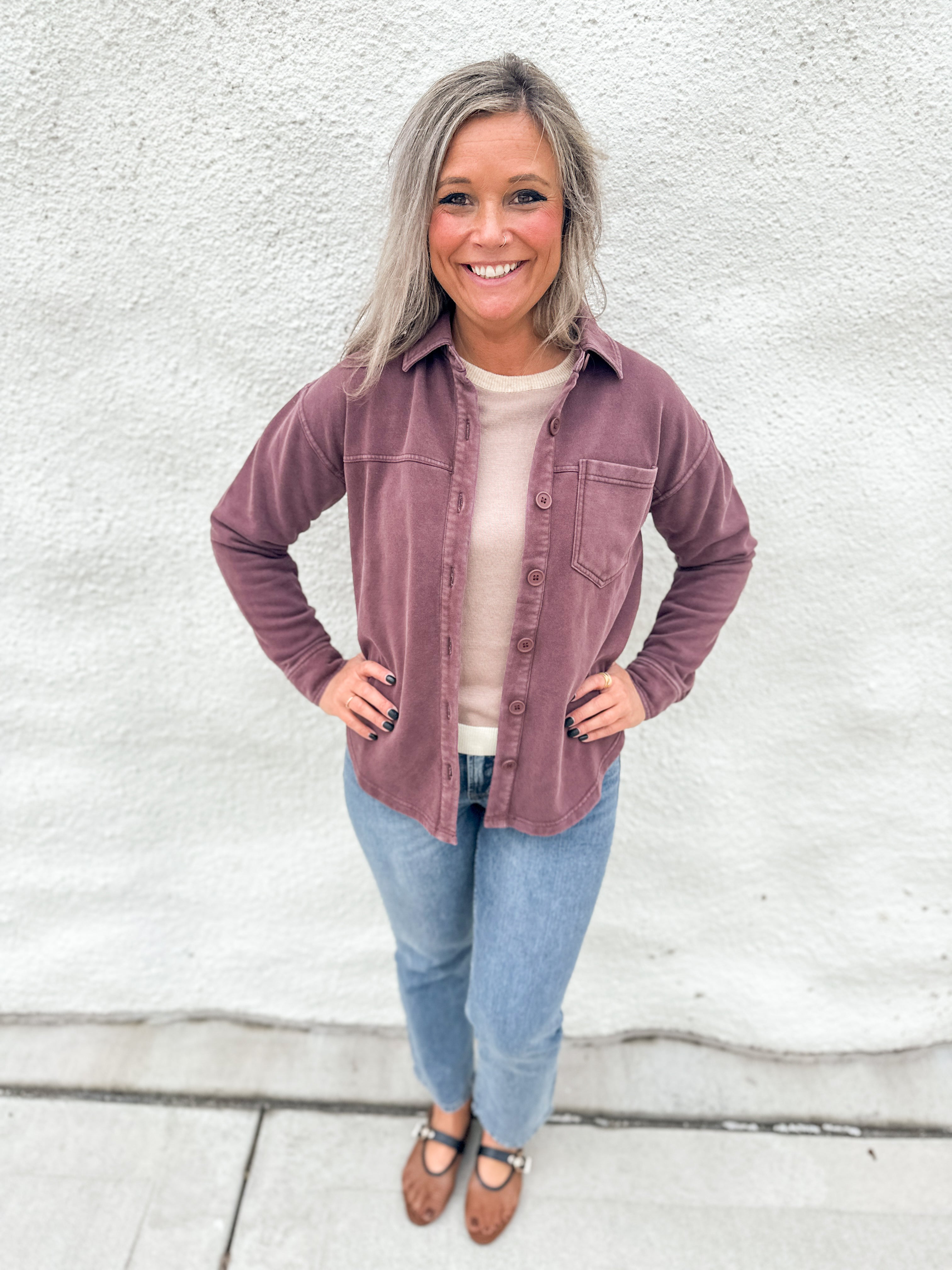 Woman wearing a washed mahogany soft button down collared soft shacket with front pocket detail on the left chest from Thread & Supply, wearing straight leg denim and brown and black mesh Mary Jane Flats