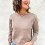 Model wearing a mocha colored lightweight crewneck sweater with wool blend, stitched v detail at neckline