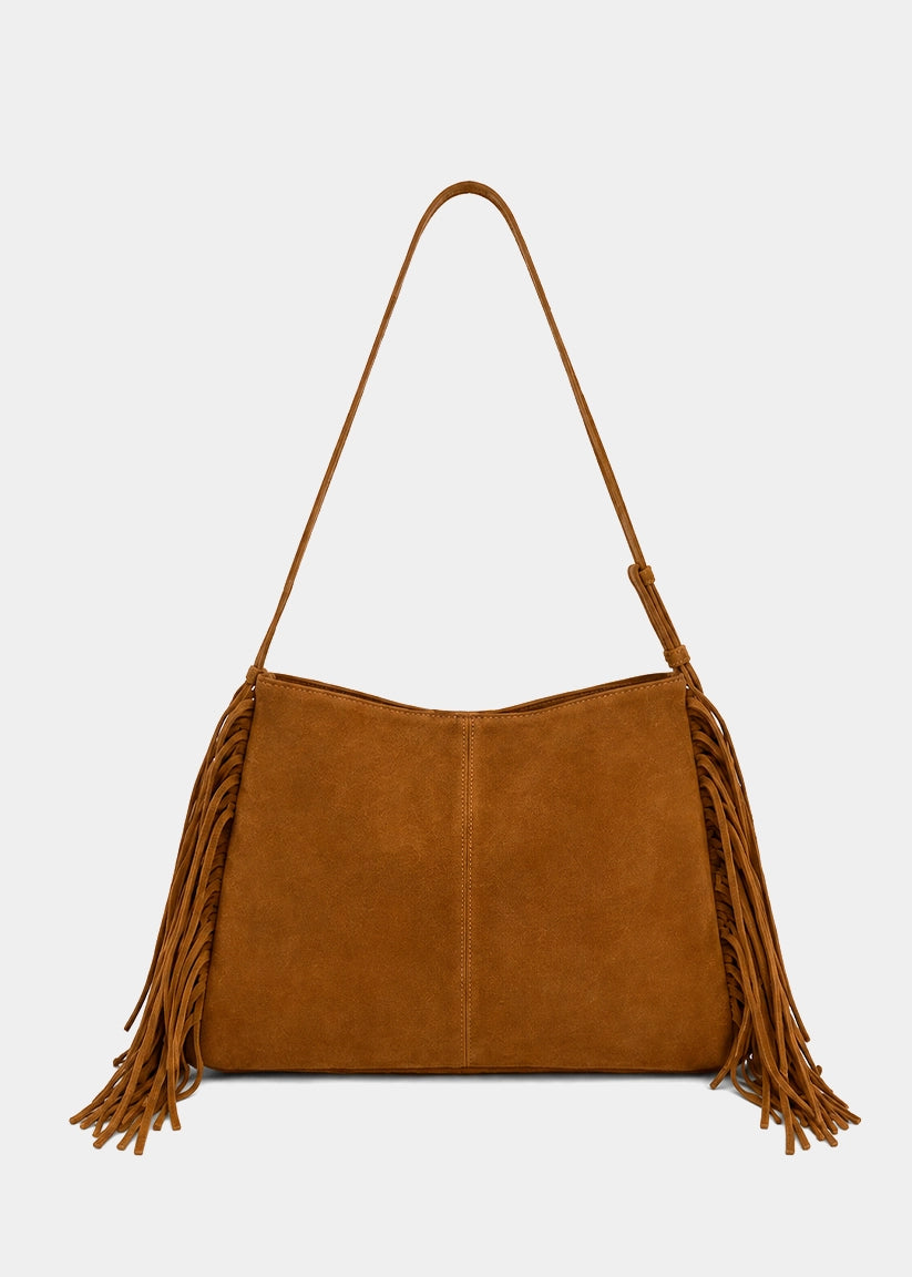 A camel brown suede shoulder bag with long fringe detailing on the sides and a thin matching shoulder strap, shown against a plain light gray background.